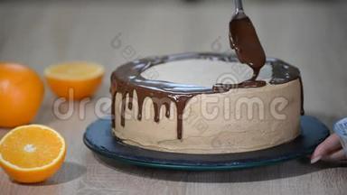 厨师挤压奶油。 巧克力蛋糕上的糖霜。 白色蛋糕上覆盖着巧克力和奶油。 巧克力蛋糕装饰。